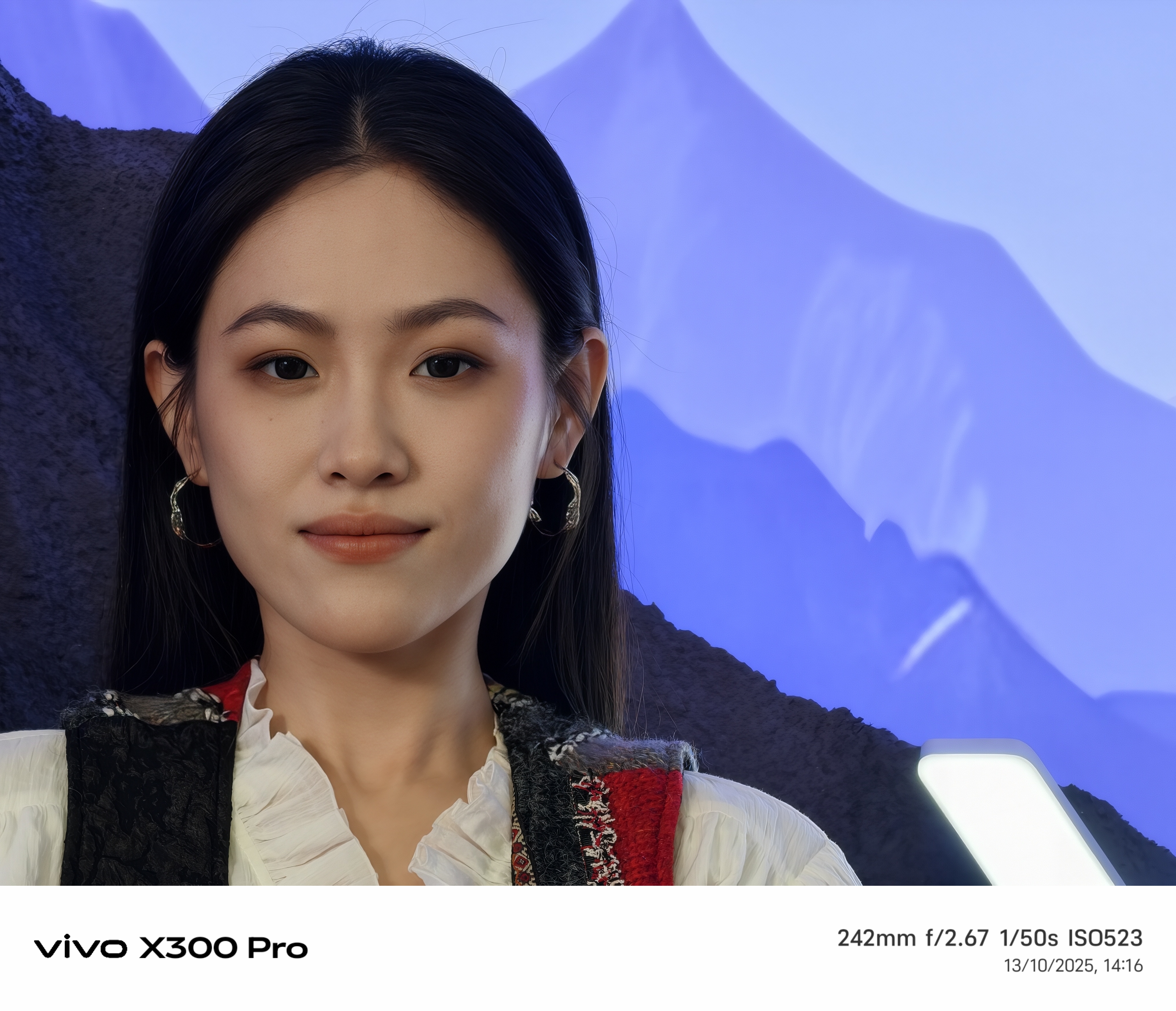 Model in front of a blue background taken on the vivo X300 pro