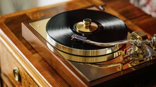 Pro-Ject The Classic Reference record player on a wooden unit.