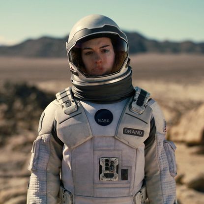 anne hathaway wears a space suit on a different planet in a still from interstellar