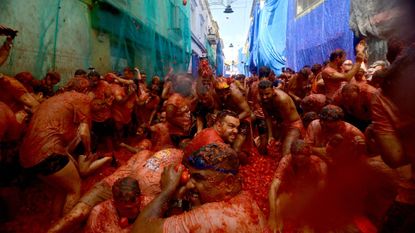 Revelers participate in the "Tomatina" annual food-battle in the Spanish eastern town of Bunol, on August 26, 2026