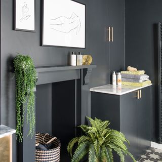 bathroom with black walls potted plants and black vanity