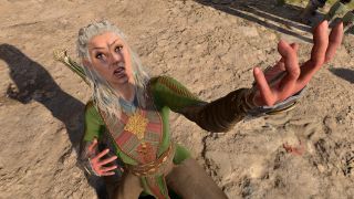 Jaheira in Baldur's Gate 3 kneeling, holding hand out, looking shocked