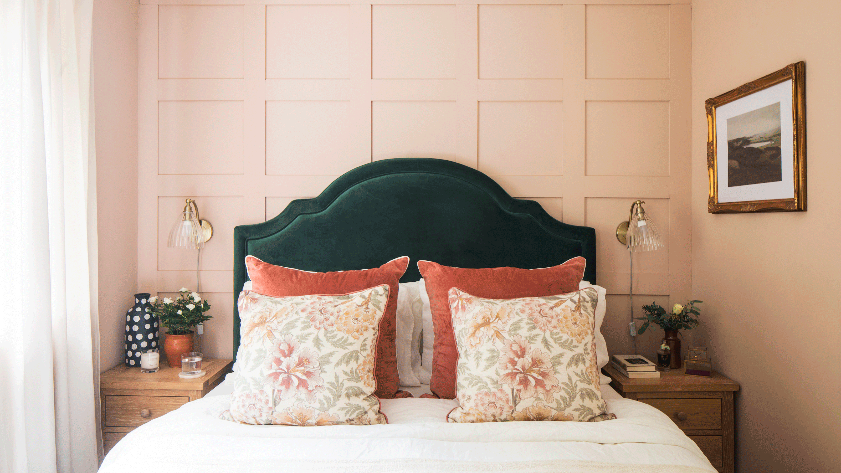 Pink bedroom with green headboard and large copper and pink cushions