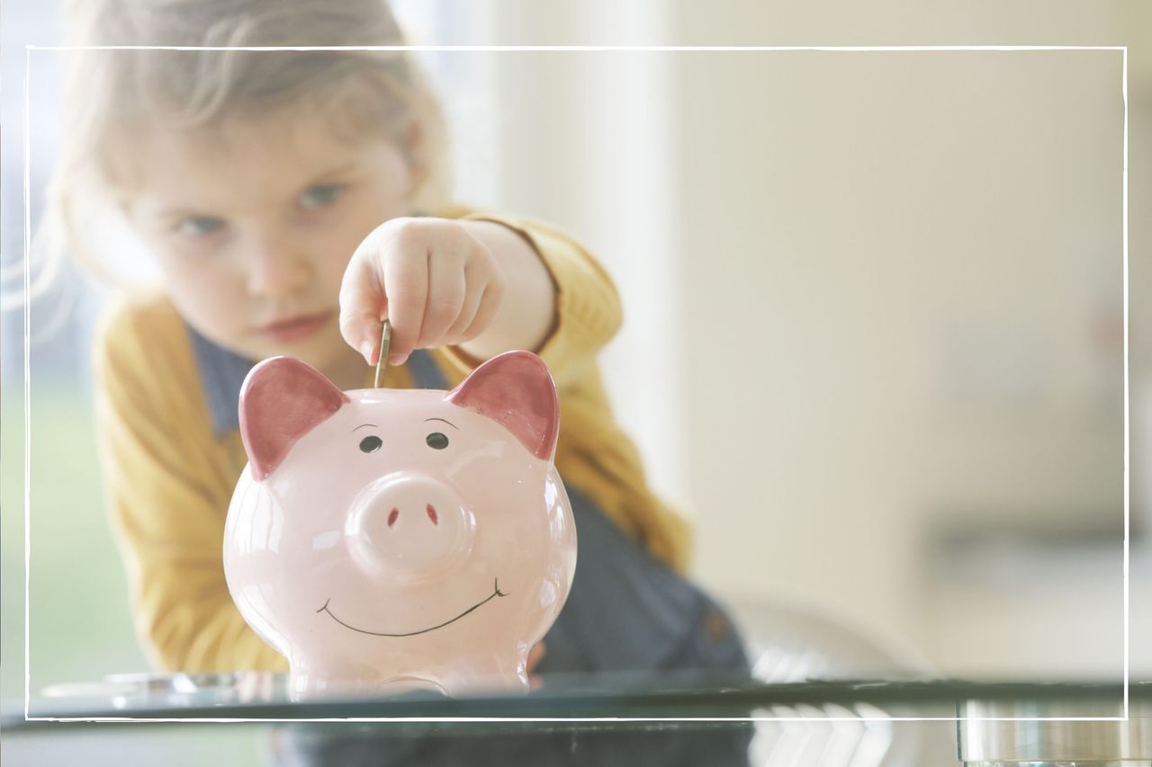 child putting coins into piggy bank