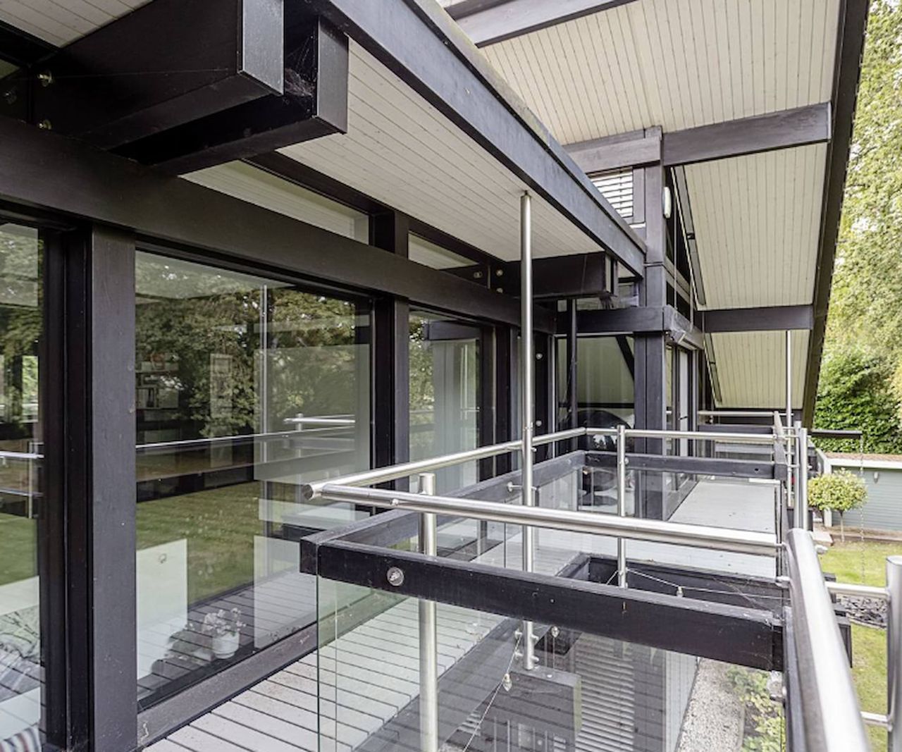 A metallic balcony looking out onto the garden