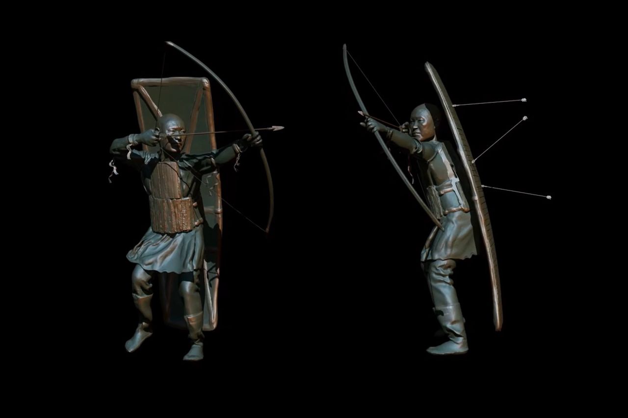 a reconstruction of a Siberian warrior pulling back his bow and arrow