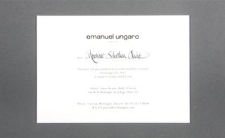 Back view of ﻿Emanuel Ungaro's invitation pictured against a grey background