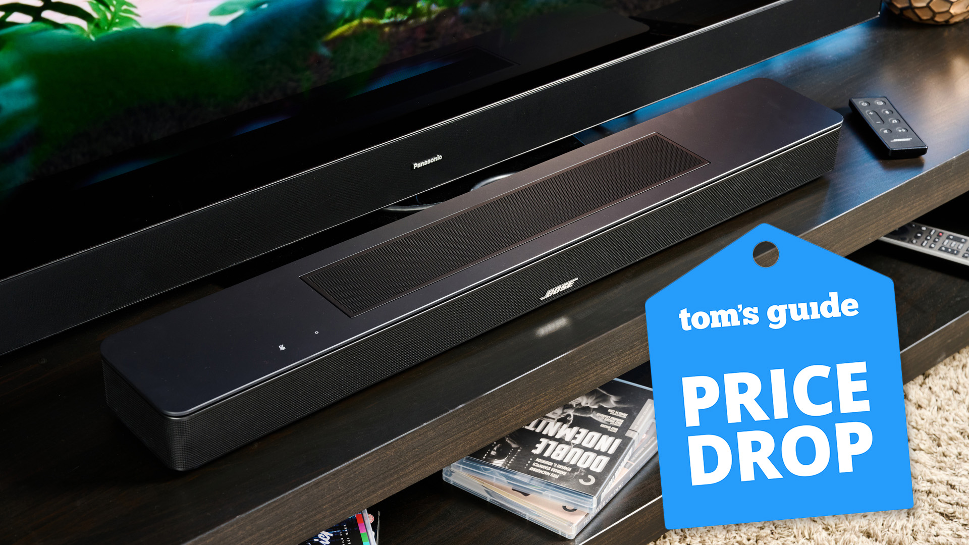 the bose smart soundbar 2024 photographed with a panasonic TV and a tom's guide blue deals badge