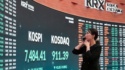 Woman looking at Korean stock market indices, KOSPI and KOSDAQ 