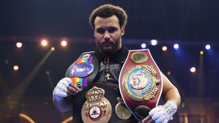 Moses Itauma celebrates victory with his belts following the WBO Inter-Continental, WBA International and Commonwealth Silver Heavyweight titles' fight between Moses Itauma and Demsey McKean as part of Oleksandr Usyk v Tyson Fury 2, Reignited card at Kingdom Arena on December 21, 2024 in Riyadh, Saudi Arabia.