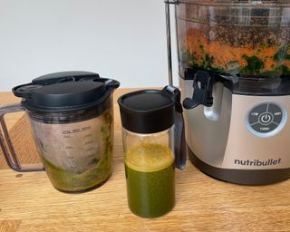 Making vegetable juice in the Nutribullet Pro on wooden dining table