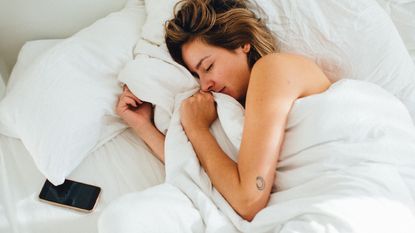 High Angle View Of Woman Sleeping On Bed - stock photo