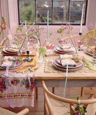 Colorful spring fresh tablescape with tall meadow flower stems in staggered bud vases, and mini DIY floral wire hoop place settings.