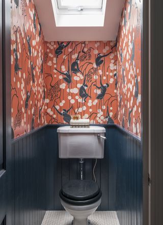 cloakroom with navy panelling and monkey wallpaper