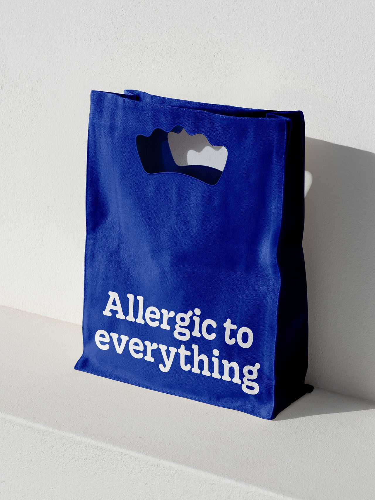 Kleenex brand on a bag that says 'allergic to everything'