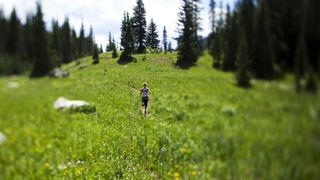 A woman running on Vail mountain