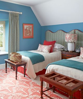 Blue bedroom with patterned curtain and headboard