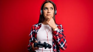 Woman holding a PS5 controller and looking confused