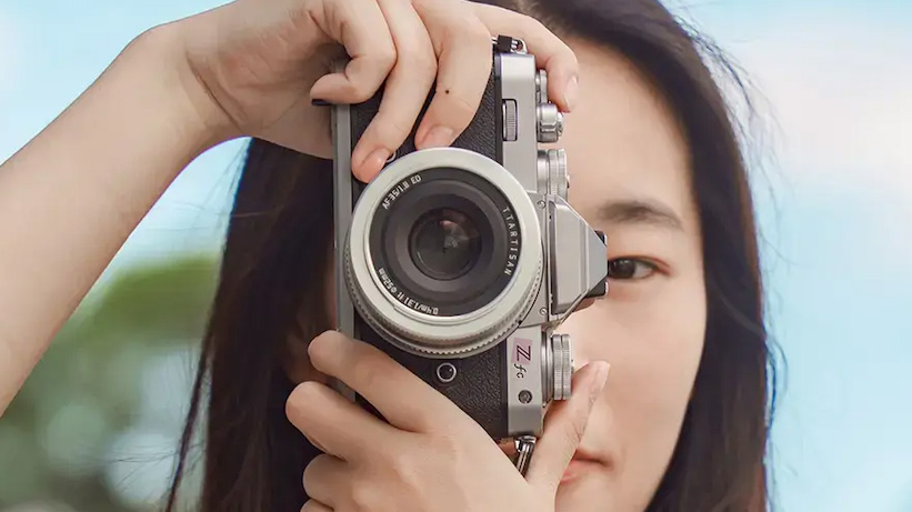 Lifestyle image of person looking through viewfinder of Nikon Z fc with TTArtisan AF 35mm f/1.8 II on the camera 