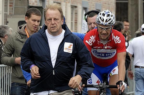 Boonen is chaperoned to the podium after winning stage four.