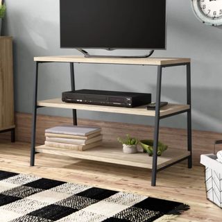 17 Stories Arturs TV Stand in bliving room with tv box and books on