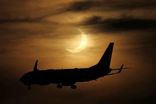 A plane flies in front of the partially eclipse sun in this stunning photo from photographers Imelda Joson and Edwin Aguirre at Black Falcon Cruise Ship Terminal in Boston on June 10, 2021.
