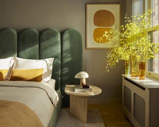 bed with green head board in New York townhouse