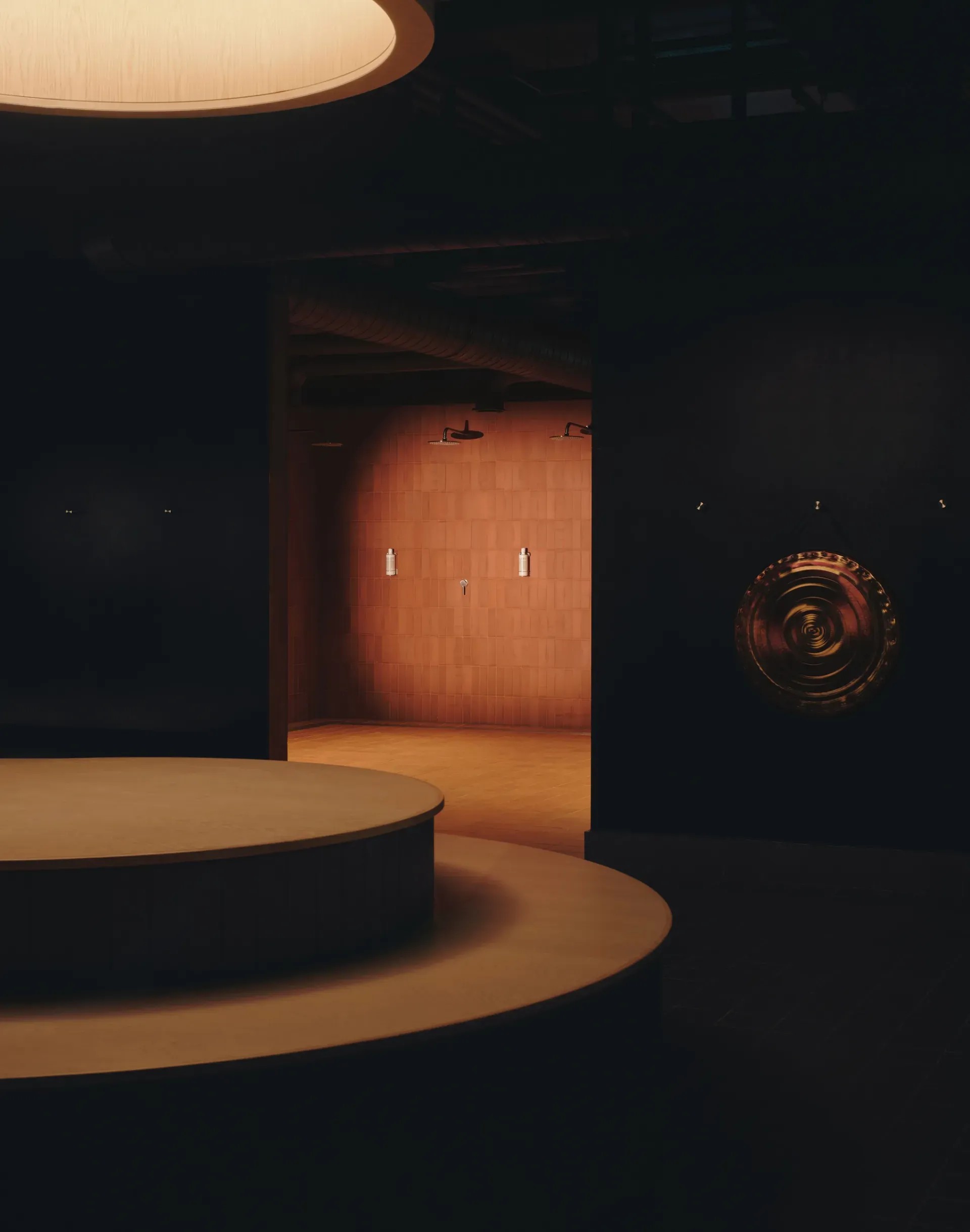 A dimly lit, earthily-tinted sauna room with a brighter porthole window on the ceiling is covered in red bricks and brown plaster.