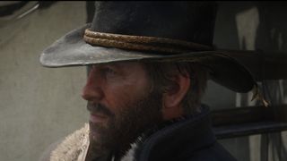 Red Dead Redemption 2 screenshot of Arthur Morgan who has a beard and wears a cowboy hat