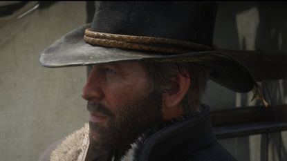 Red Dead Redemption 2 screenshot of Arthur Morgan who has a beard and wears a cowboy hat