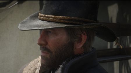 Red Dead Redemption 2 screenshot of Arthur Morgan who has a beard and wears a cowboy hat