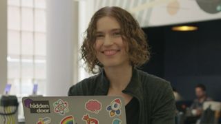 Hidden Door co-founder and CEO Hilary Mason sits behind her laptop in the company's office.