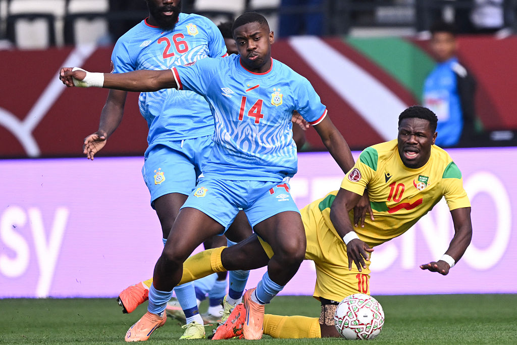 Democratic Republic Of Congo's midfielder #14 Noah Sadiki and Benin's forward #10 Aiyegun Tosin vie during the Africa Cup of Nations (CAN) Group D football match between Democratic Republic of Congo and Benin at Al Medina Stadium in Rabat on December 23, 2025. (Photo by SEBASTIEN BOZON / AFP)