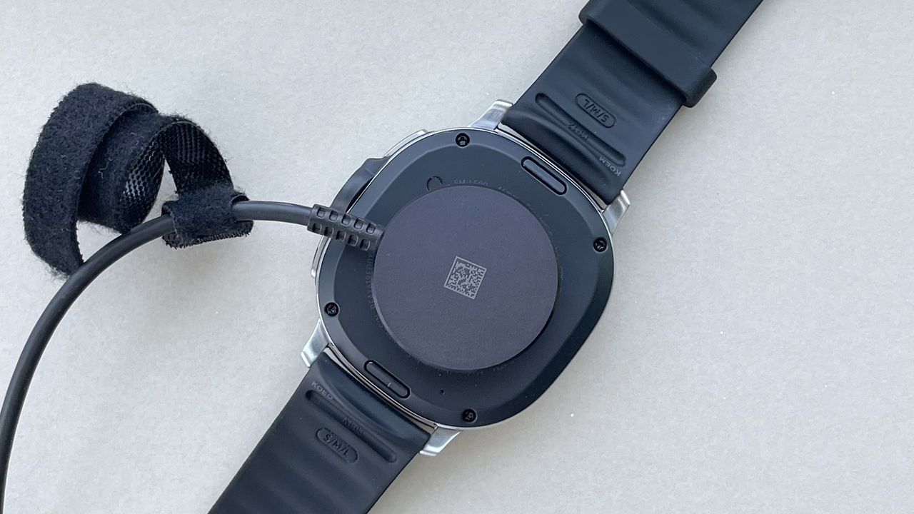 Close-up of the back of the Samsung Galaxy Watch 8 Classic showing the charger connected