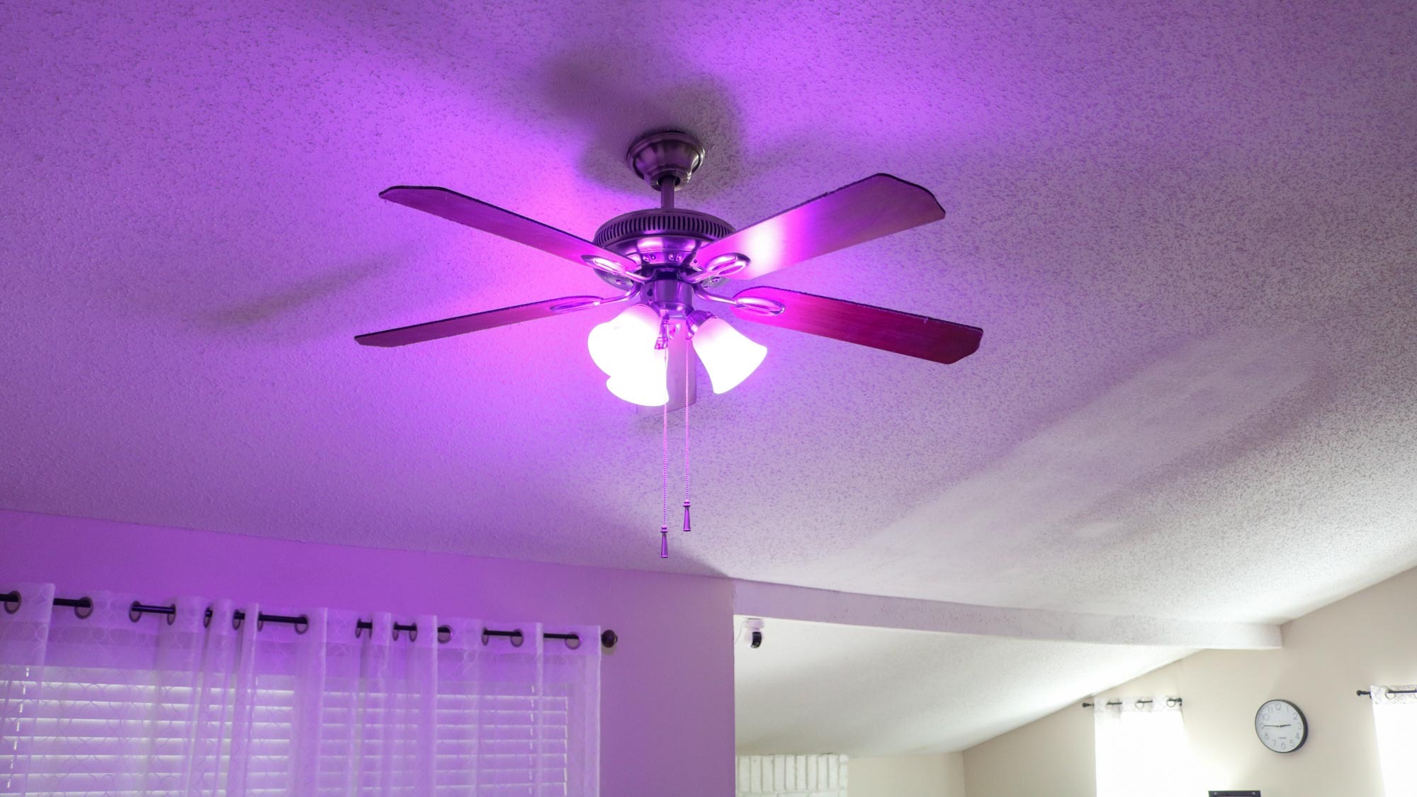 Three colored smart light bulbs in a ceiling fan