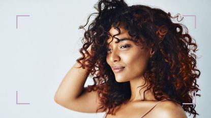 Woman with curly hair learning how to get rid of dandruff