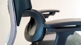 A black mesh OdinLake Ergo PLUS 743 office chair in an office hallway