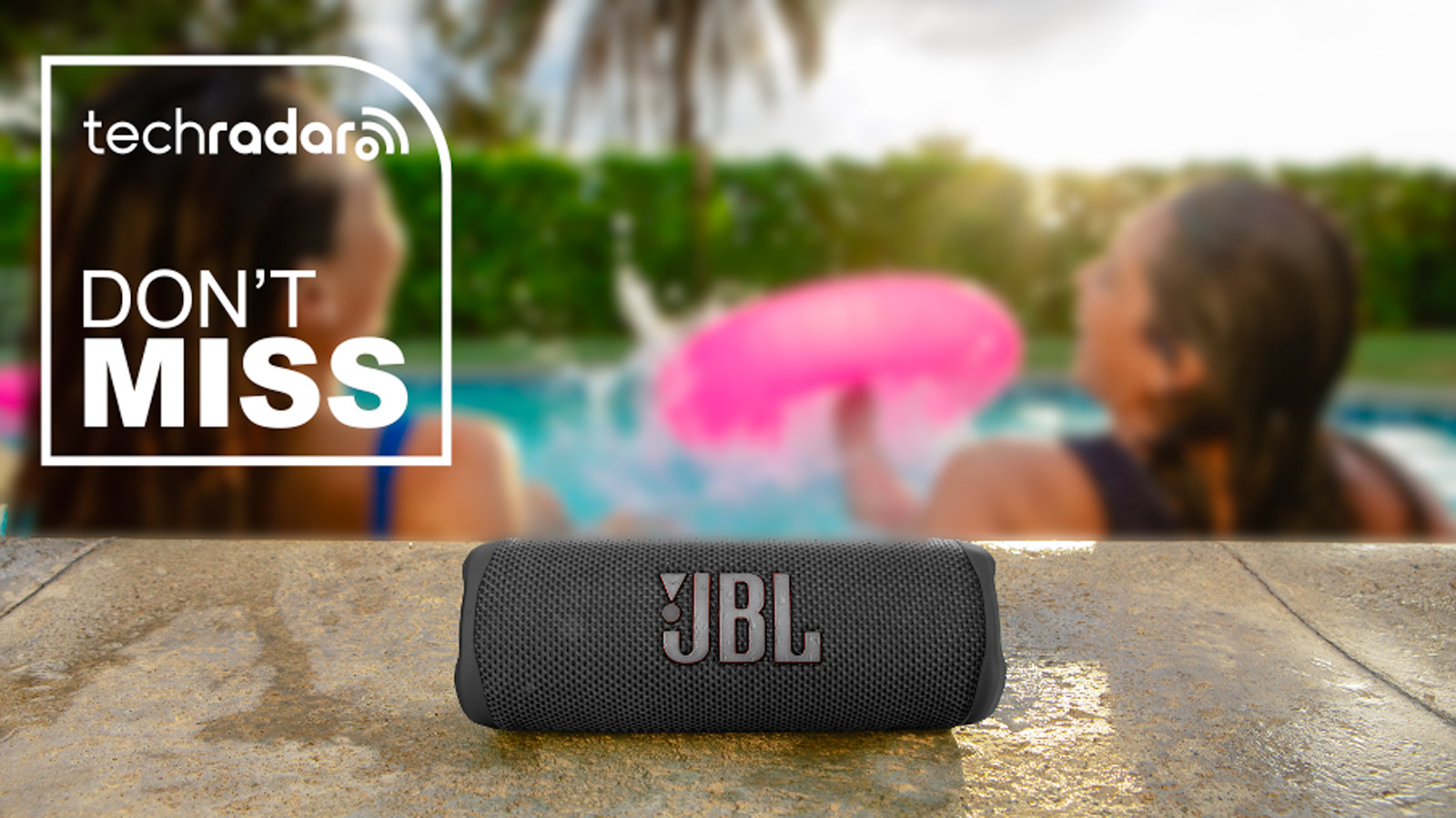 A black JBL Flip 6 pictured beside a swimming pool.