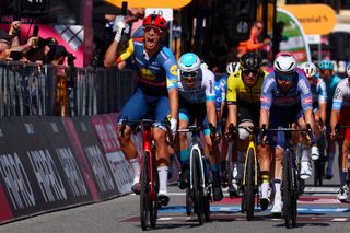 Team Lidl-Trek's Italian rider Jonathan Milan celebrates as he crosses the finish line to winn the 4th stage of the 107th Giro d'Italia cycling race, 190 km between Acqui Terme and Andora, on May 7, 2024 in Andora. (Photo by Luca Bettini / AFP)