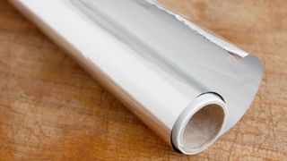 aluminum foil on wooden surface
