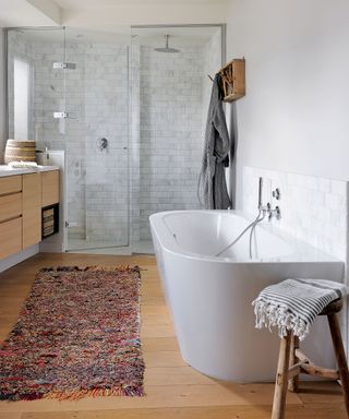 An example of modern bathroom ideas showing a white bath and walk in shower in a Californian casual aesthetic