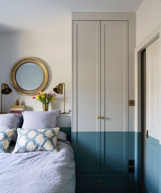 bedroom with gray and blue walls and wardrobe