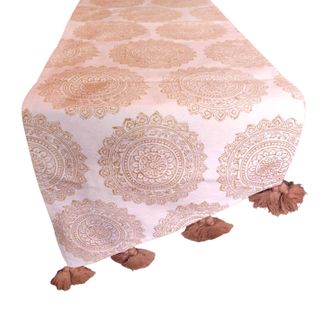 A neutral block printed table runner with tassels