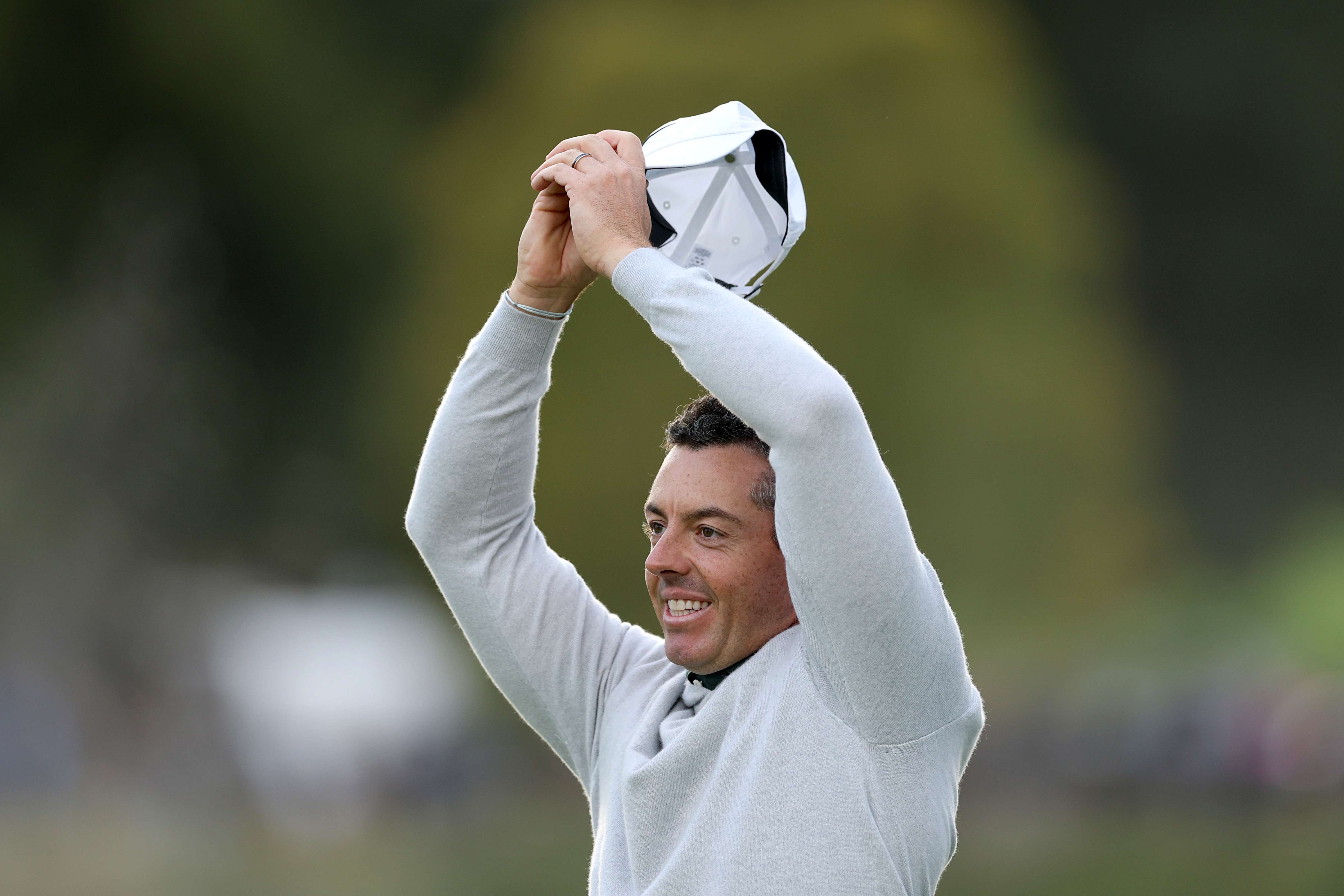 Rory McIlroy waves his hands in the air