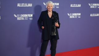 Judi Dench in an all-black outfit on the red carpet at the BFI London Film Festival 2022