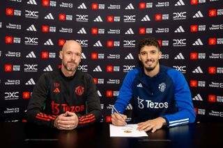 Altay Bayindir of Manchester United poses with Manager Erik ten Hag after signing for the club at Carrington Training Ground on September 1, 2023 in Manchester, England.