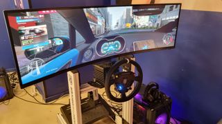 A Revosim RS Pure sim racing setup attached to a sim rig and an ultrawide display.