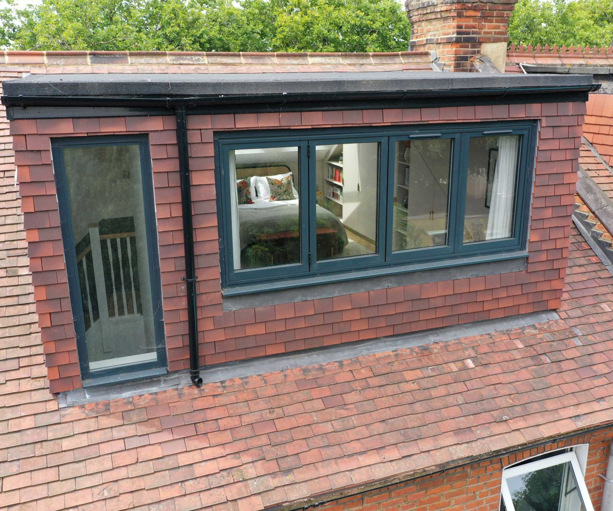 dormer loft conversion with grey windows and clay hung tile cladding