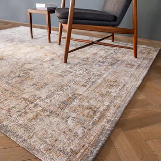 oversized John Lewis Ushak rug with a chair on top of it