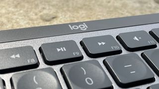 The Logitech logo at the top of the Logitech MX Keys S keyboard.